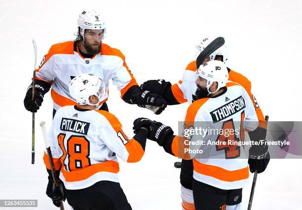 Nate Thompson of the Philadelphia Flyers is congratulated by teammates Ivan Provorov,Matt Niskanen and Tyler Pitlick after Thompson scored an...