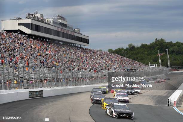 Aric Almirola, driver of the Smithfield Hometown Original Ford, leads the field during the NASCAR Cup Series Foxwoods Resort Casino 301 at New...