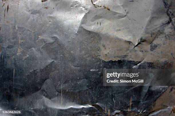 crumpled, dented, scratched and mud splattered stainless steel metal sheet - metal bildbanksfoton och bilder