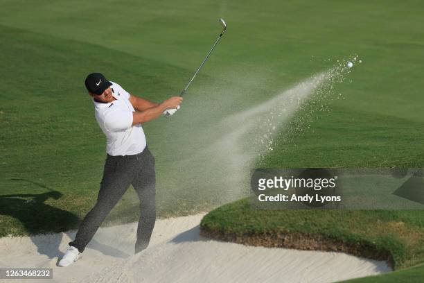 Brooks Koepka of the United States plays a shot from a bunker on the 18th hole during the final round of the World Golf Championship-FedEx St Jude...