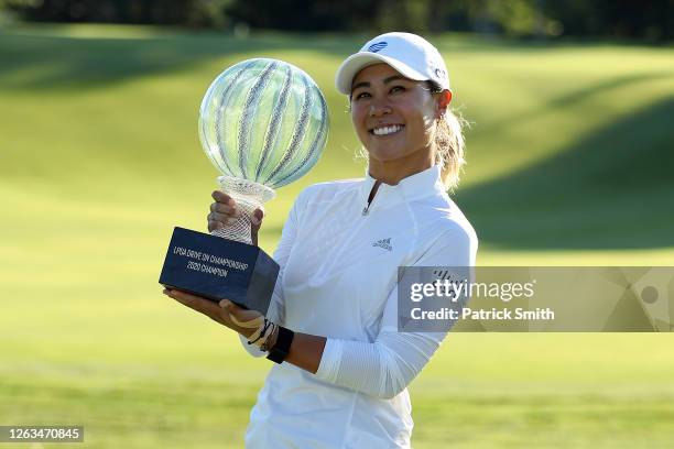 Danielle Kang celebrates with the trophy on the 18th green after winning the LPGA Drive On Championship at Inverness Club on August 2, 2020 in...