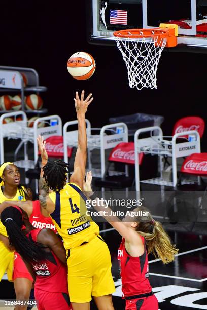 Candice Dupress of the Indiana Fever shoots under pressure from Blake Dietrick of the Atlanta Dream during the first half at Feld Entertainment...