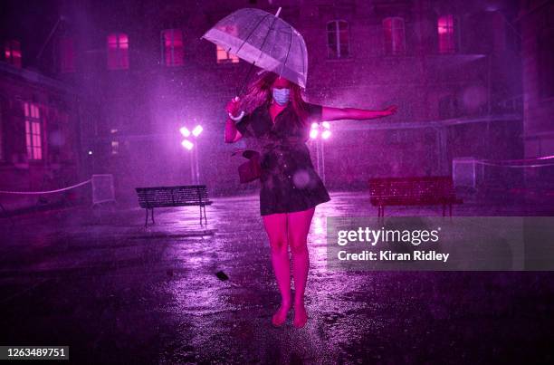 Visitor dances at the 'Purple Rain' installation at the Lycée Jacques-Decour on August 02, 2020 in Paris, France. Part of Festival Paris l'Eté, the...