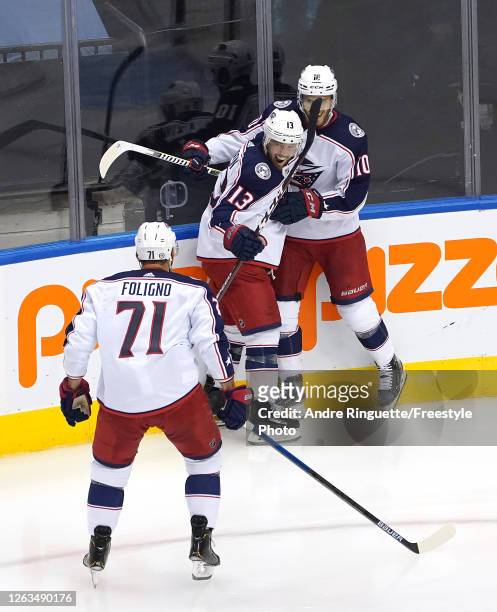 Cam Atkinson of the Columbus Blue Jackets is congratulated by teammates Alexander Wennberg and Nick Foligno after he scored a goal in the third...