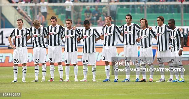 Juventus players observe a minuute silence before their Italian Serie A football match Juventus versus Catania at Massimino Stadium on September 25,...