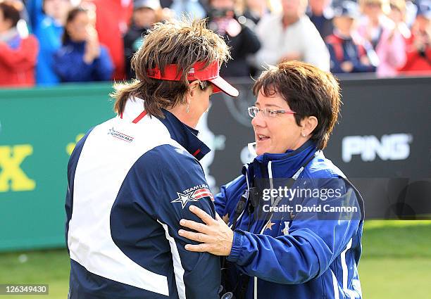 Europe Captain Alison Nicholas embraces USA Captain Rosie Jones on the 1st tee during the singles matches on day three of the 2011 Solheim Cup at...