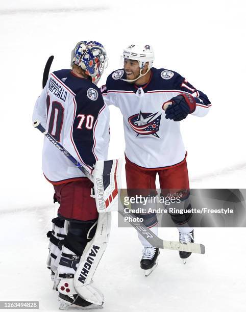 Cam Atkinson of the Columbus Blue Jackets congratulates Joonas Korpisalo after he recorded the team's first shut out after defeating the Toronto...