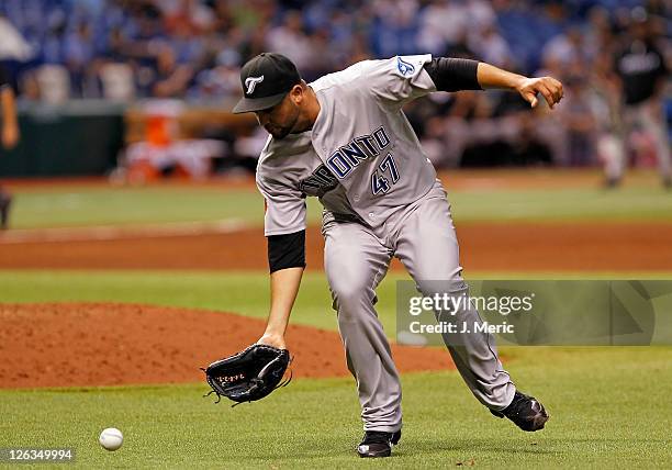 Pitcher Luis Perez of the Toronto Blue Jays fields a ground ball against the Tampa Bay Rays during the game at Tropicana Field on September 23, 2011...