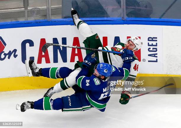 Jared Spurgeon of the Minnesota Wild collides with Tyler Motte of the Vancouver Canucks in Game One of the Western Conference Qualification Round...