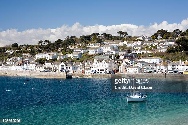 a yacht floating on the clear blue water in the small seaside harbour and coastal town of st mawes. - english cottage stock pictures, royalty-free photos & images