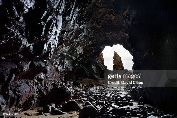 view inside one of the caves at plemont on the north coast of jersey. - cave stock pictures, royalty-free photos & images