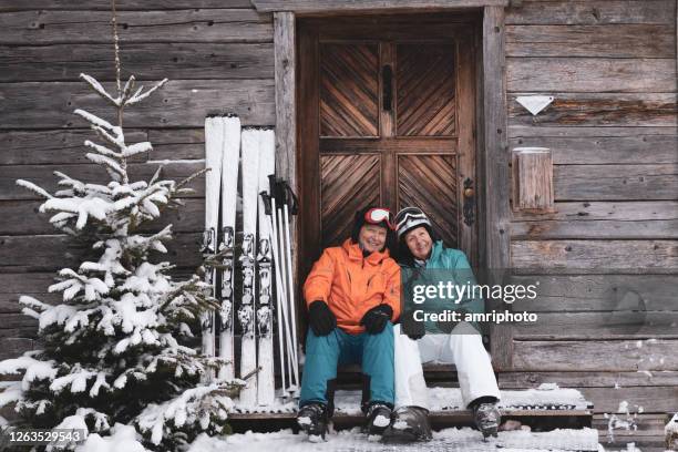 happy active senior couple on ski holidays - senior winter sport stock pictures, royalty-free photos & images
