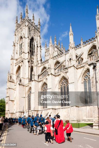 sealed knot an english civil war / revolution battle reinactment walks past the spectacular exterior of york minster, a cathedral in york city, east yorkshire, england, uk - church tower restoration appeal stock pictures, royalty-free photos & images