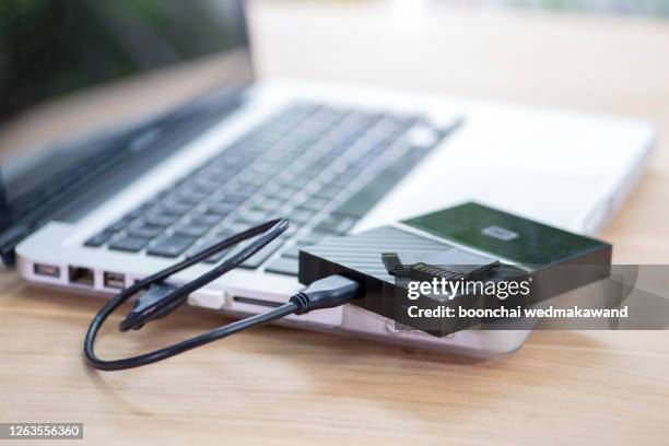 external hard drive and memory card - computer backup stockfoto's en -beelden