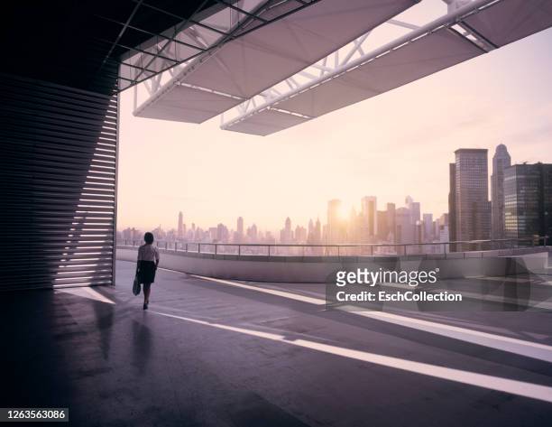 woman on roof terrace with view of modern city - classic photos of the american skyscraper stock pictures, royalty-free photos & images