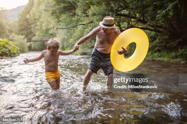 on a river with my grandpa - grandson stock pictures, royalty-free photos & images
