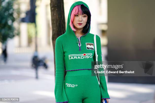 Guest wears a Paradiso hoodie sweater with flared sleeves and a "Marvelous" patch, wool pants, during London Fashion Week September 2019 on September...