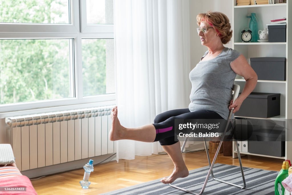 Senior women exercise at home