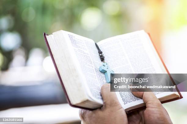 close up of young man hands hold and reading holy bible.christian faith concept stock photo. - religiös text bildbanksfoton och bilder