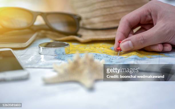 red pin on a world map. travel planning. - a journey to planet sanity stock pictures, royalty-free photos & images