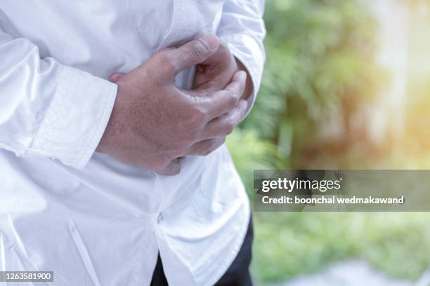 businessman stomachache attack of bacteria - human liver stock pictures, royalty-free photos & images