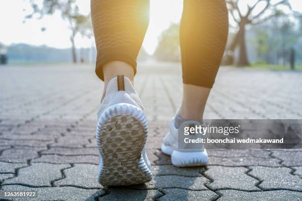 runner feet running on road closeup on shoe. - walking foto e immagini stock