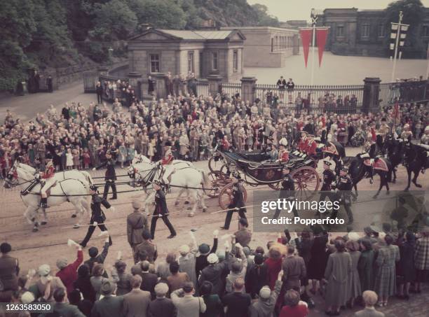 Queen Elizabeth II and Prince Philip, Duke of Edinburgh ride in a carriage to receive the honours of Scotland at St Giles' Cathedral in Edinburgh...