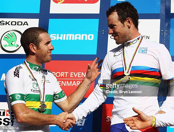 Mark Cavendish of Great Britain shakes hands with Matthew Goss of Australia after winning the Men's Eilte Road Race at the UCI Road World...