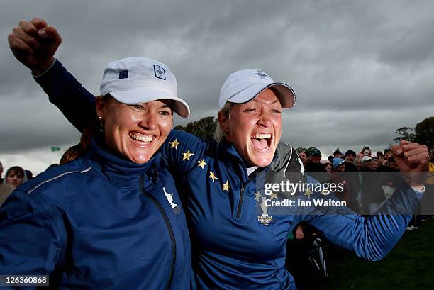 Sophie Gustafson and Suzann Pettersen of Europe celebrate their team's victory on the 18th green during the singles matches on day three of the 2011...