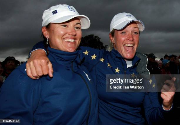 Sophie Gustafson and Suzann Pettersen of Europe celebrate their team's victory on the 18th green during the singles matches on day three of the 2011...