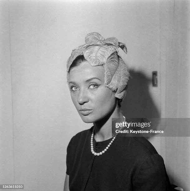 Mannequin présentant un chapeau de plumes en forme de feuilles, création de Rose Valois, à Paris, France le 20 juillet 1966.