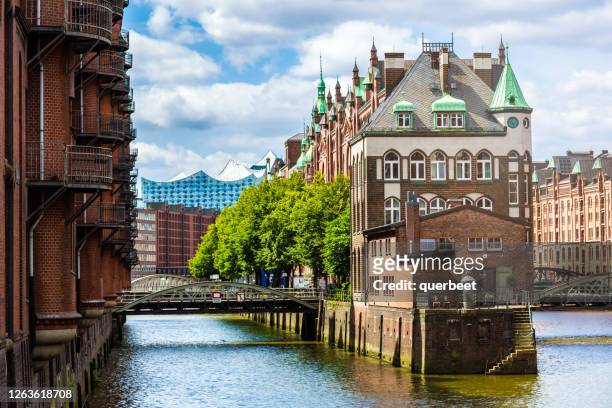 historic speicherstadt in hamburg with elbphilharmonie in the background, germany - elbphilharmonie stock pictures, royalty-free photos & images