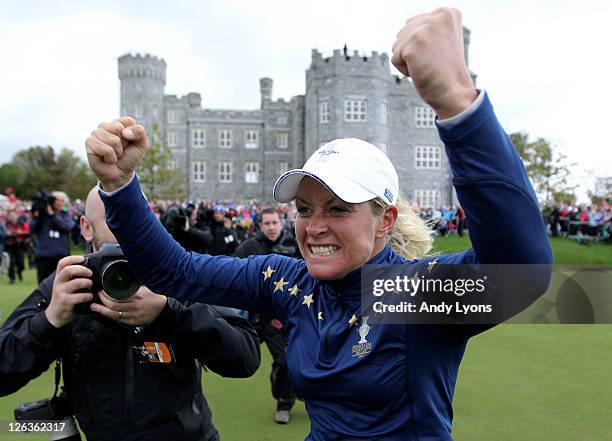 Suzann Pettersen of Europe celebrates her team's 15-13 victory on the 18th green during the singles matches on day three of the 2011 Solheim Cup at...