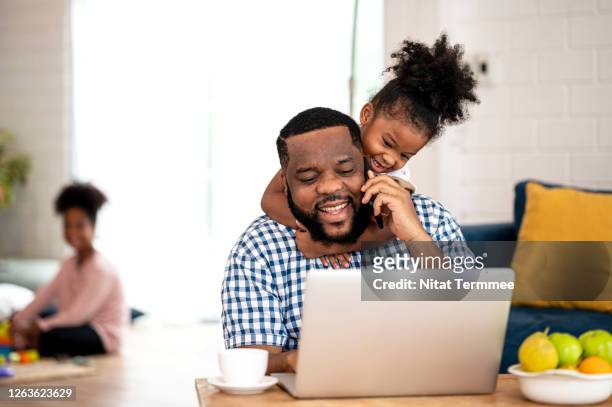 papa please play with me!. a african father working from home, talking on call while cute little daughter disturb her father to stop working. - human body part stock-fotos und bilder