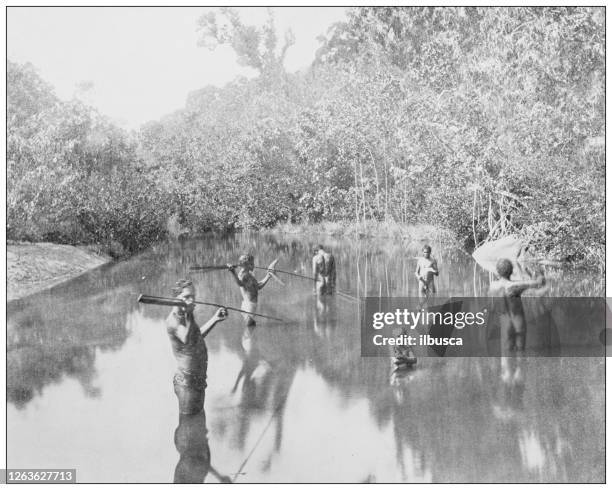 antique black and white photograph: african natives fishing - man spear fishing stock illustrations