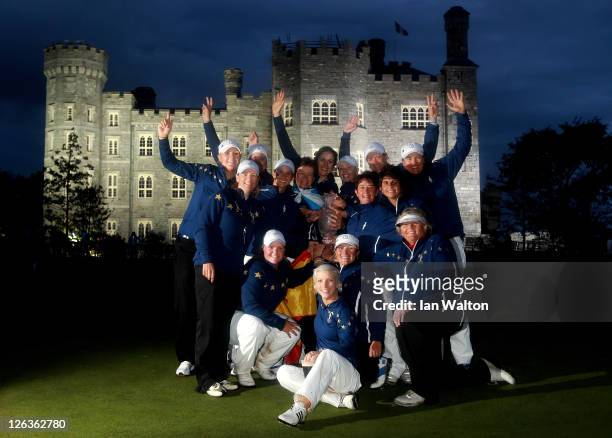 The European team celebrate with the trophy following their 15-13 victory during the singles matches on day three of the 2011 Solheim Cup at Killeen...