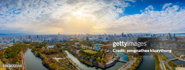 aerial view panoramic of castle with japanese garden and city office building skyscraper - castle square photos et images de collection