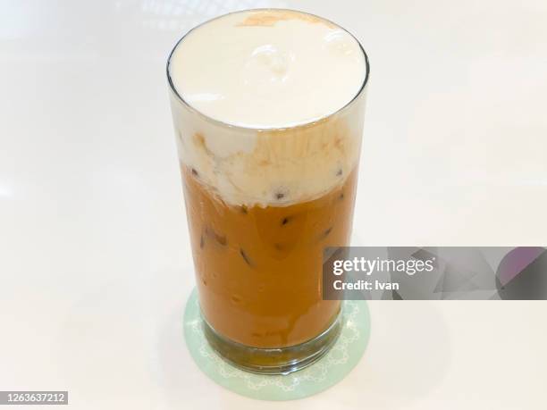 traditional thai cuisine, a glass of iced thai milk tea - sugar in glass stock pictures, royalty-free photos & images