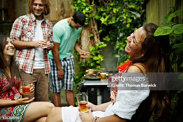 group of friends cooking at barbecue laughing - 20 days stock pictures, royalty-free photos & images