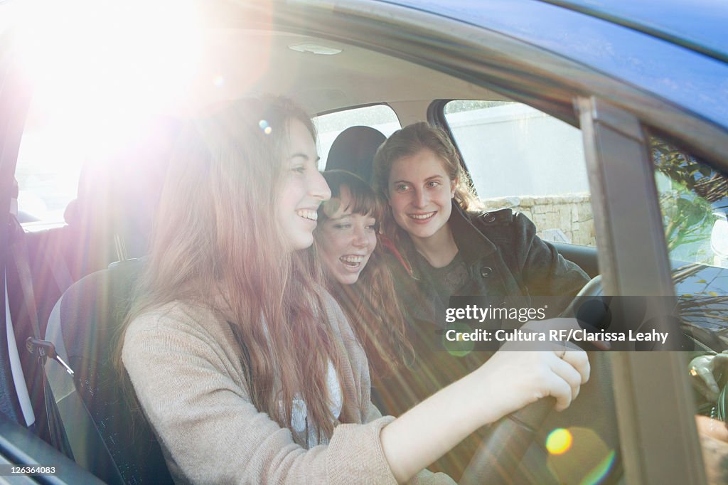 Teenage girls riding in car together