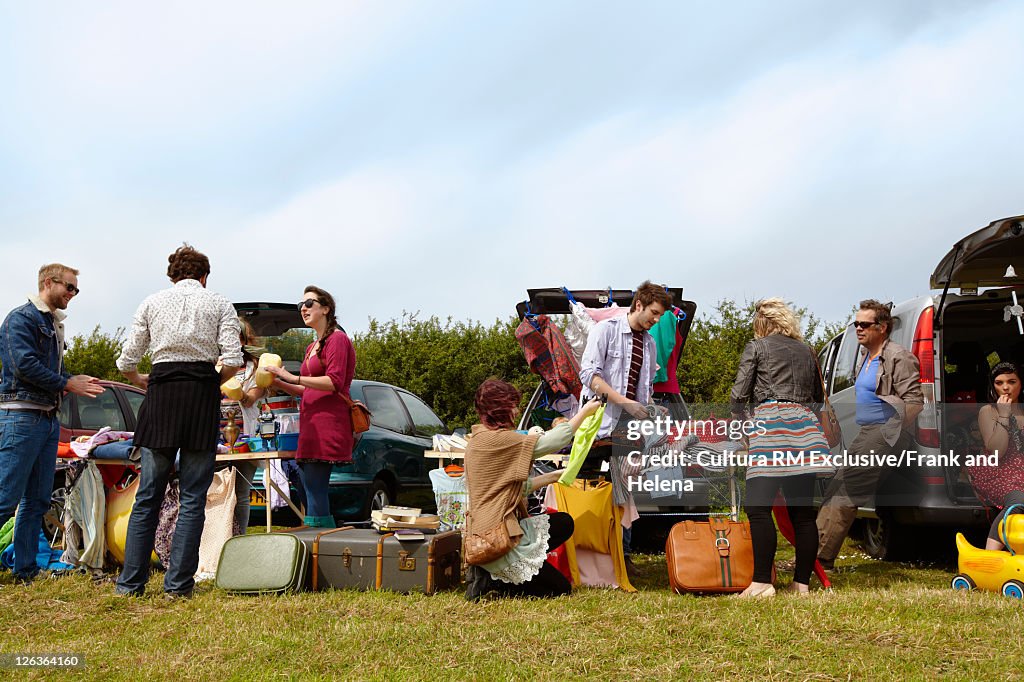 People selling things from car trunks