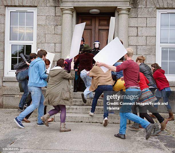 protesters running towards riot police - strike back stock pictures, royalty-free photos & images