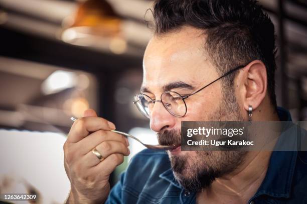 happy adult man eating desert - man eating pie stock pictures, royalty-free photos & images