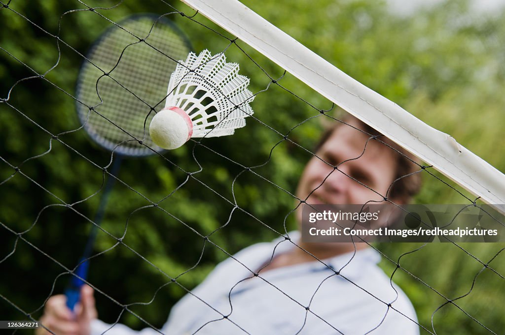 Badminton shuttlecock stuck in net