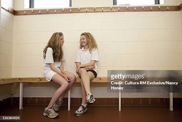 students talking in locker room - locker room stock pictures, royalty-free photos & images