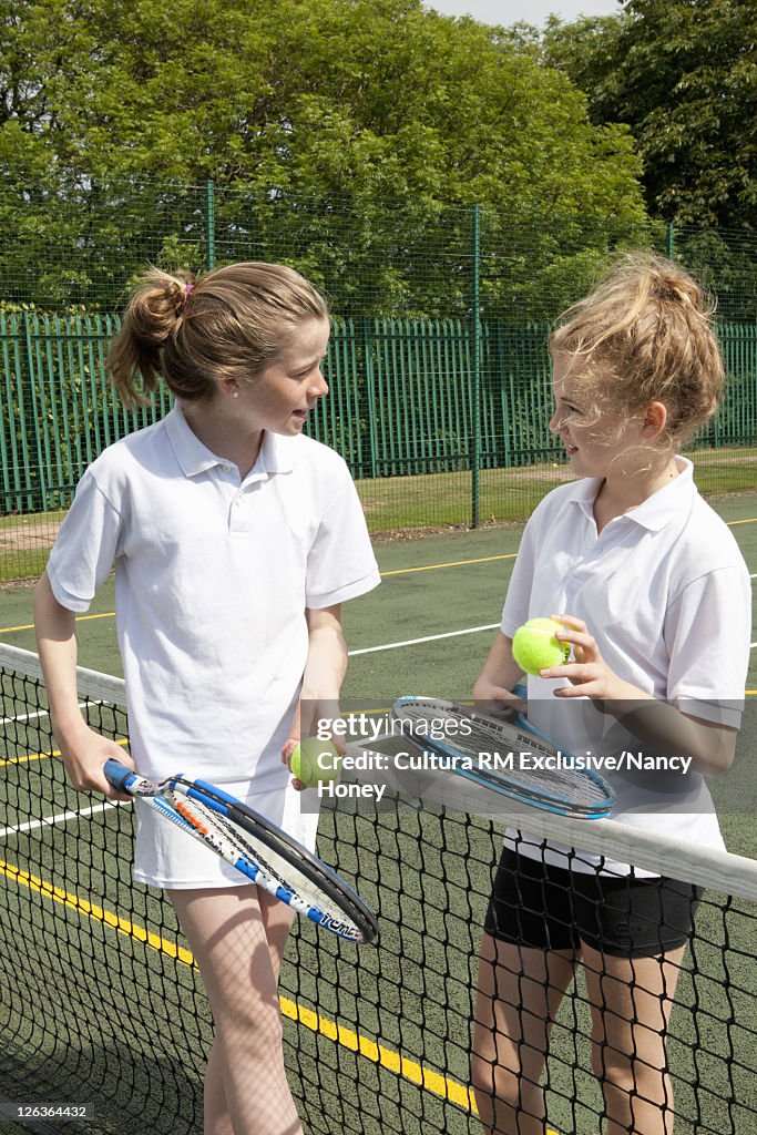 Children playing tennis on court