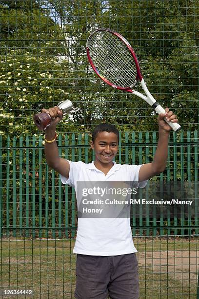 tennis player with trophy on court - kid winning stock pictures, royalty-free photos & images