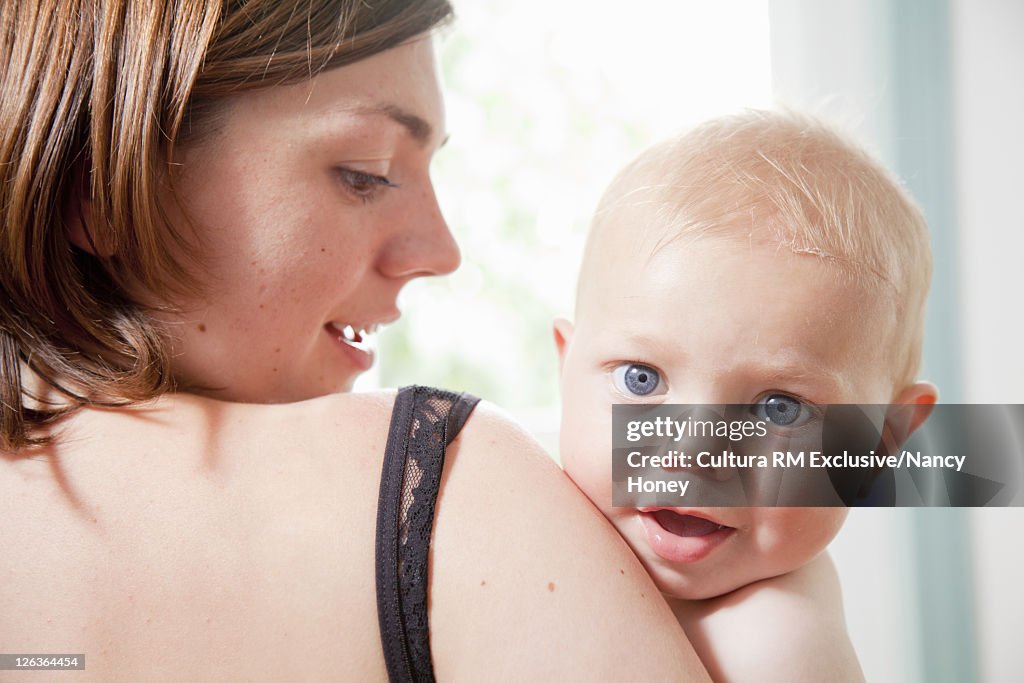 Infant resting on mother's shoulder