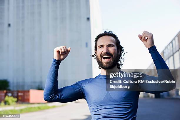 runner cheering in industrial area - refshaleøen stock pictures, royalty-free photos & images