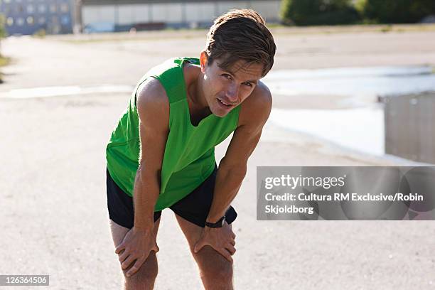 runner resting in industrial area - refshaleøen stock pictures, royalty-free photos & images